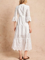 White eyelet tiered midi dress with elastic waist and bell sleeves.