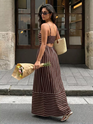 Brown striped maxi dress with smocked bodice and cutout detail.