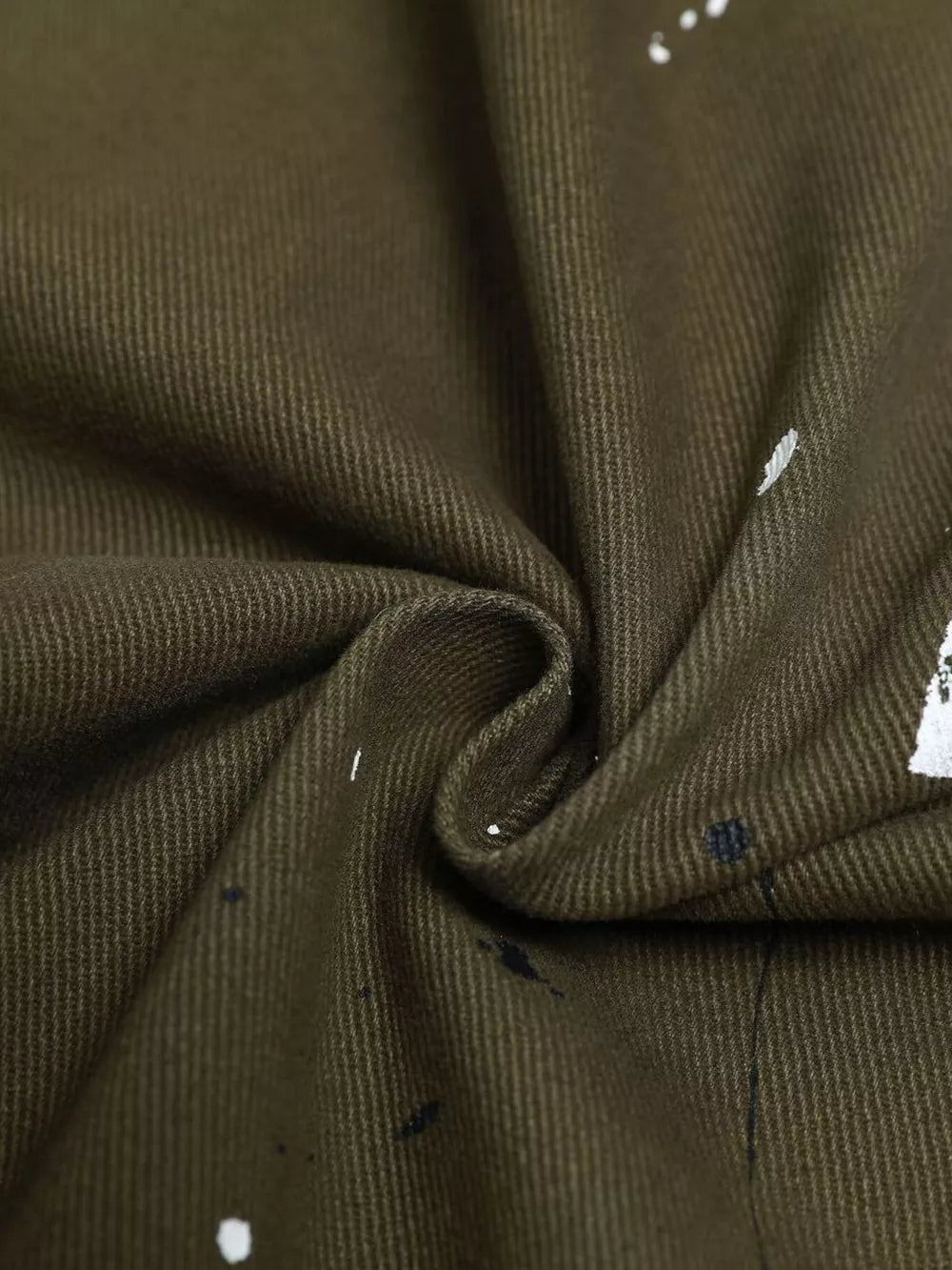 Olive green cotton cargo pants with white and black paint splatter detail.