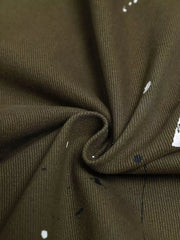 Olive green cotton cargo pants with white and black paint splatter detail.