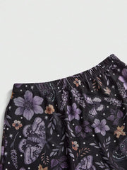 Black midi skirt with a whimsical floral and butterfly print, featuring an elastic waistband.