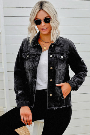 Black distressed denim trucker jacket with frayed hem and distressed details.