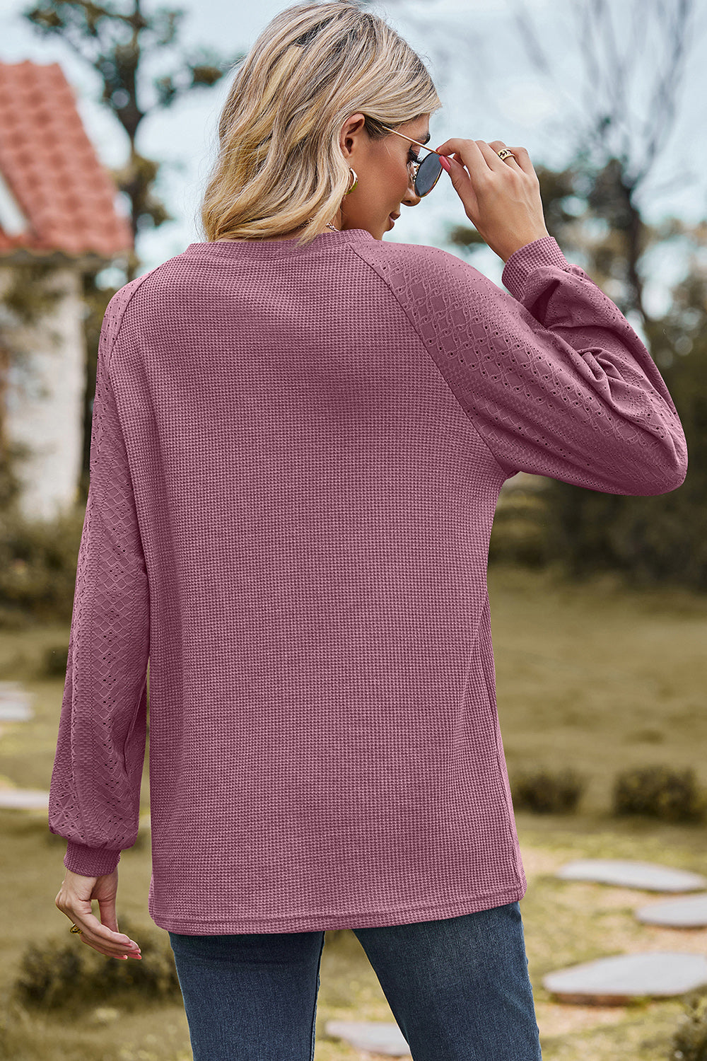 Lilac waffle knit raglan sleeve top with eyelet detail on sleeves.