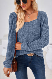 Dusty blue ribbed square neck top with puffed sleeves and a textured knit.