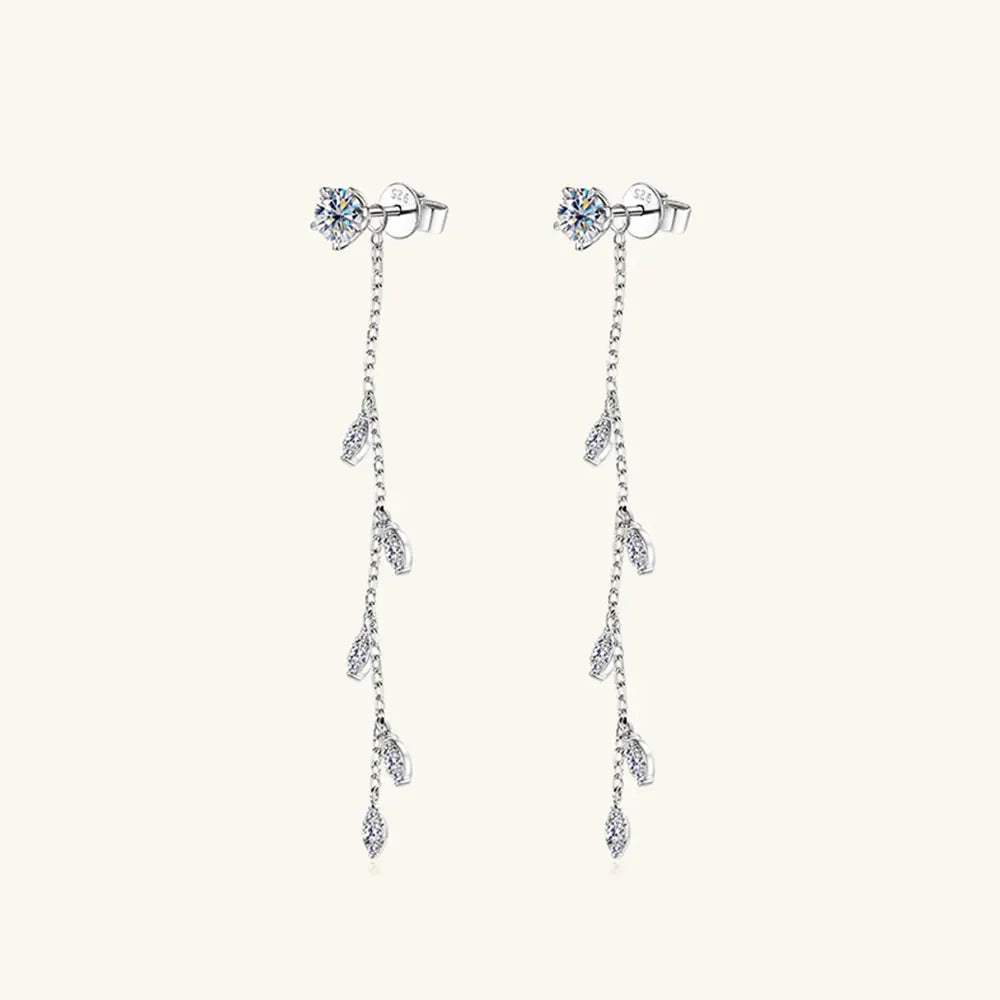 Silver dangling crystal vine earrings with delicate chain and leaf-shaped accents.