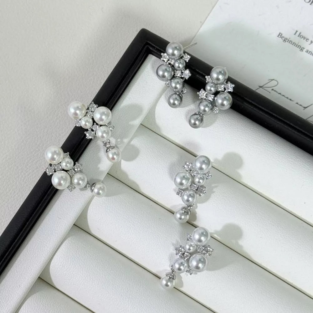 Sophisticated pearl and zircon cluster earrings in light gray and white.