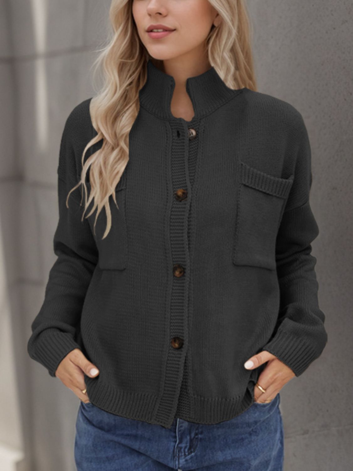 Gray acrylic knit cardigan with stand collar, buttons, and chest pockets.