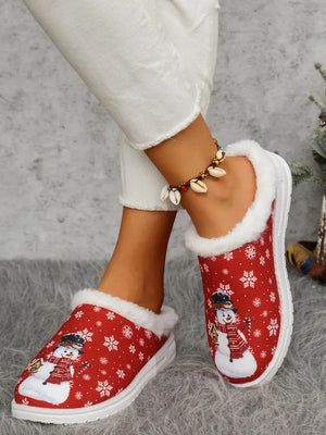 Red snowman print sherpa lined holiday slides with white snowflakes.