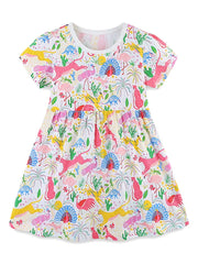 White cotton blend dress with a colorful animal and dinosaur print, short sleeves, and gathered waist.