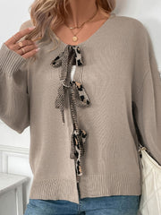 Mocha acrylic cardigan with leopard print tie-front and balloon sleeves.