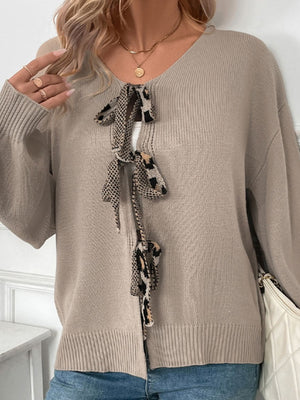 Mocha acrylic cardigan with leopard print tie-front and balloon sleeves.