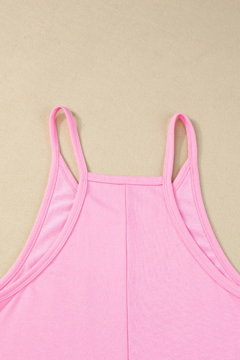 Pink spaghetti strap romper with a square neckline and patch pockets