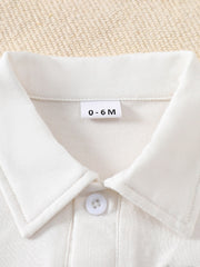 White cotton baby outfit with collar and button detail, size 0-6M.