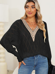 Black openwork dolman sweater with lace trim V-neck and long sleeves.