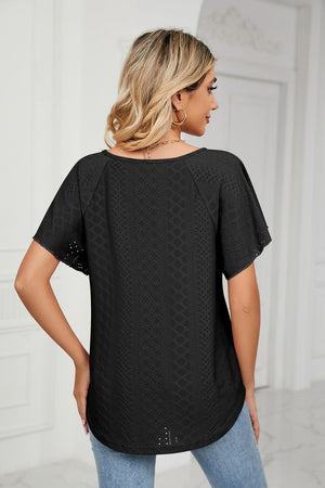 Black eyelet tie-neck blouse with flutter sleeves and a curved hem.