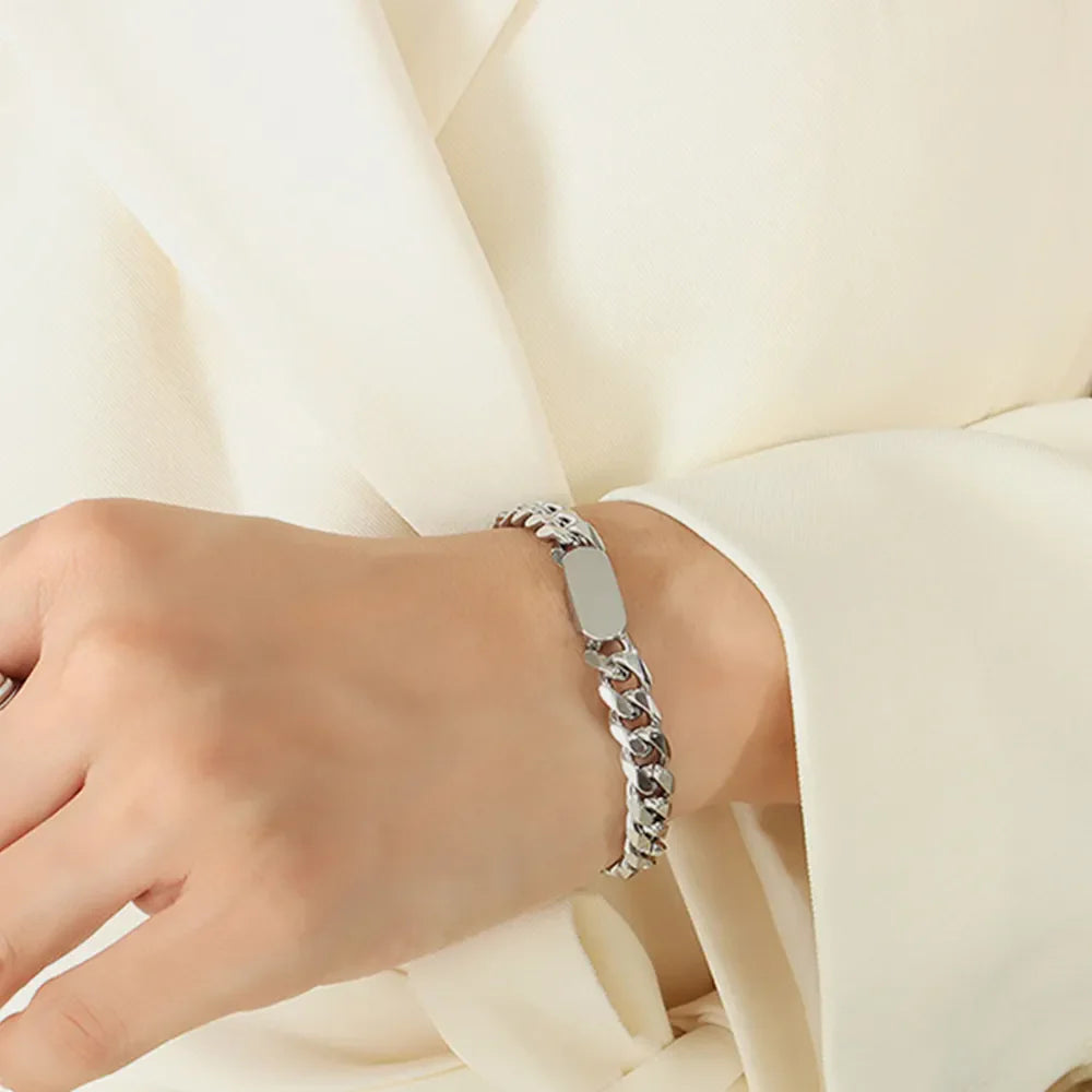 Silver chunky curb chain ID bracelet with a blank tag detail.