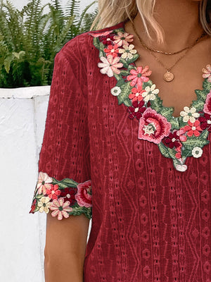 Burgundy embroidered eyelet peasant blouse with floral V-neck and sleeve trim.
