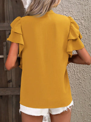 Gold blouse with ruffled short sleeves and a plunge neckline shown from the back.