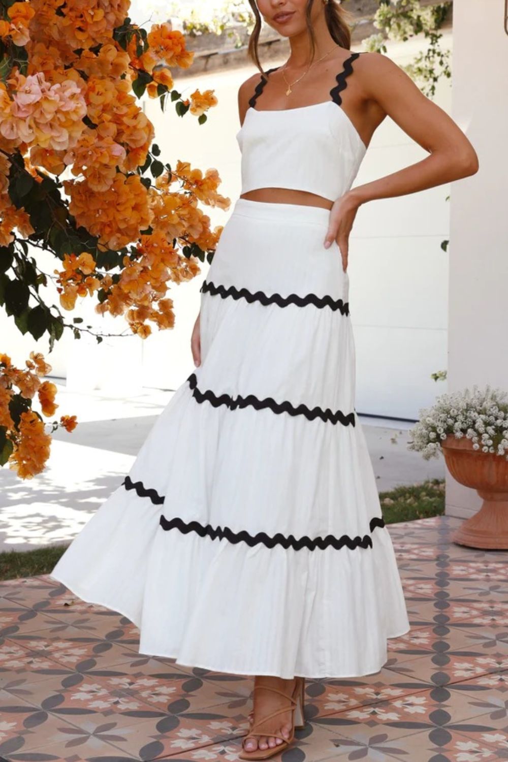 White crop top and tiered maxi skirt set with black scalloped trim detail.