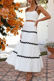 White crop top and tiered maxi skirt set with black scalloped trim detail.