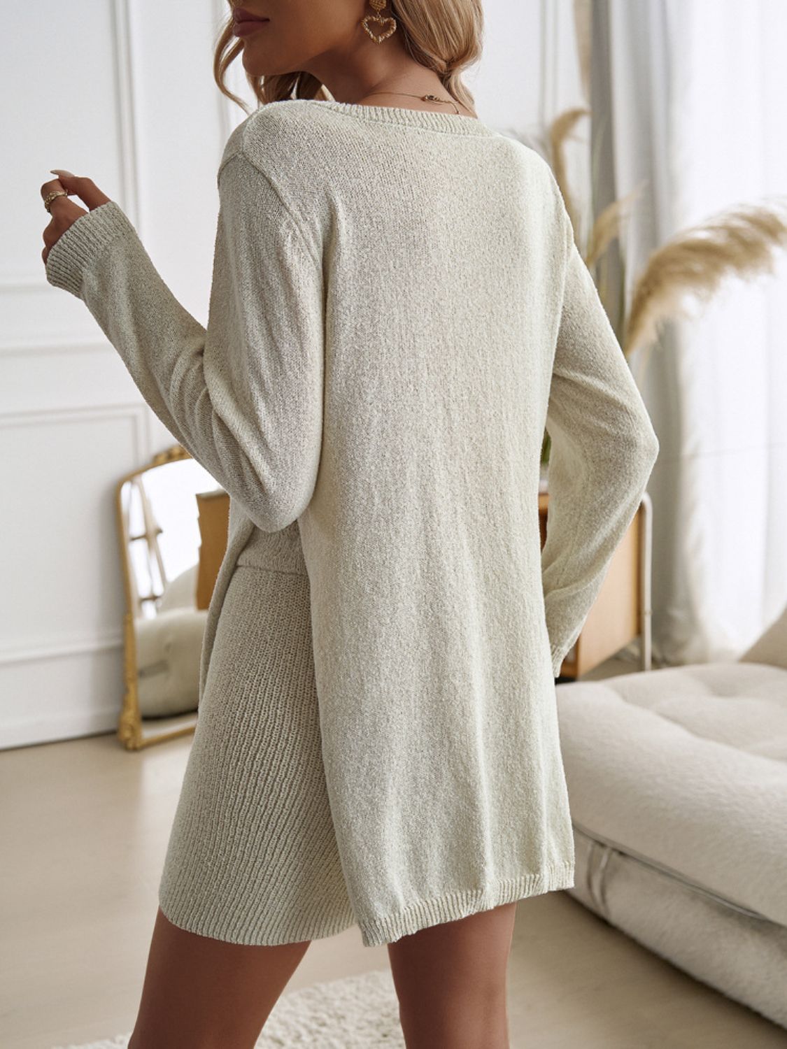Beige textured knit co-ord set with side slit skirt and long sleeves.