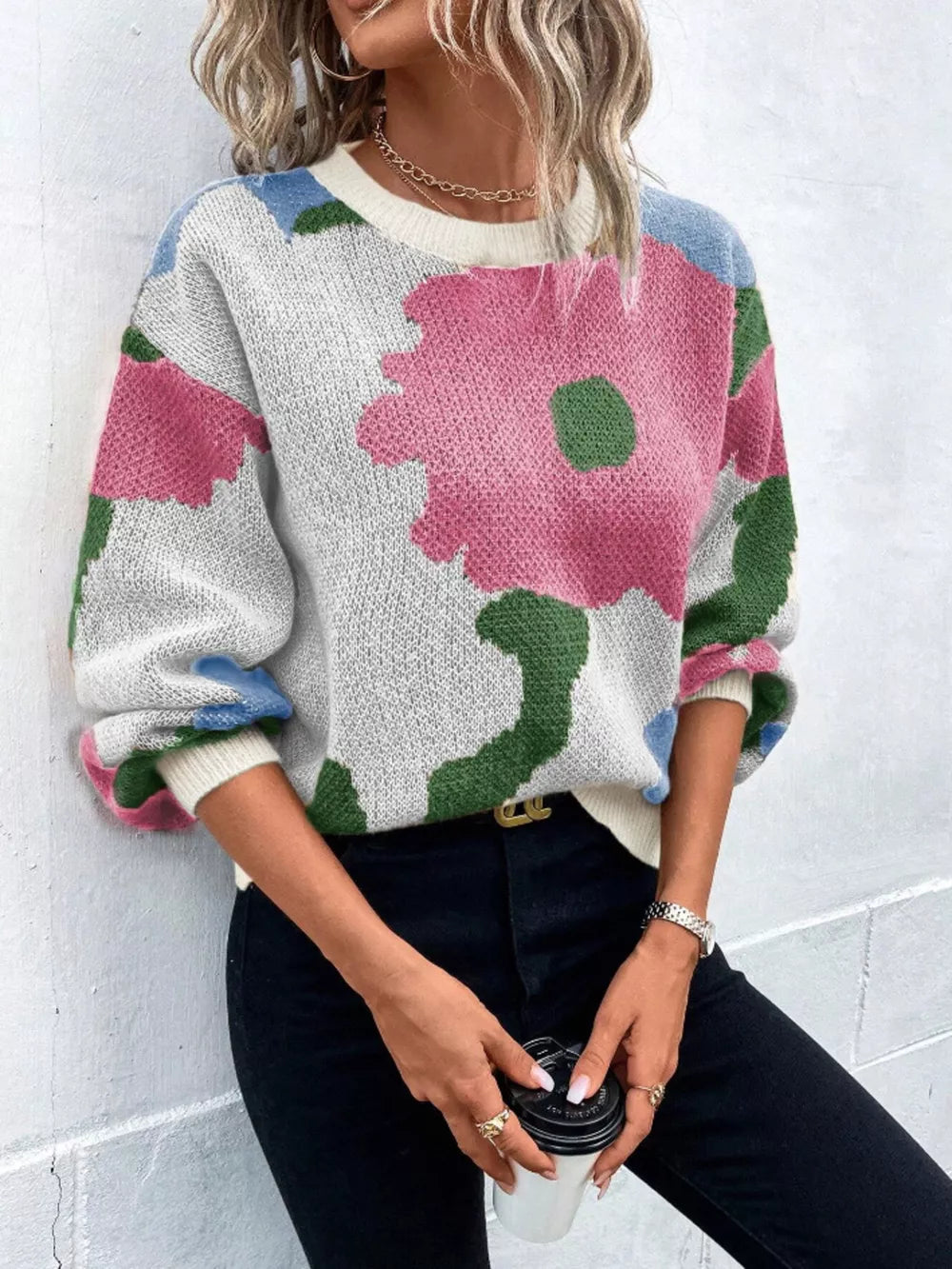 Abstract floral knit sweater with round neck in white, pink, green, and blue.