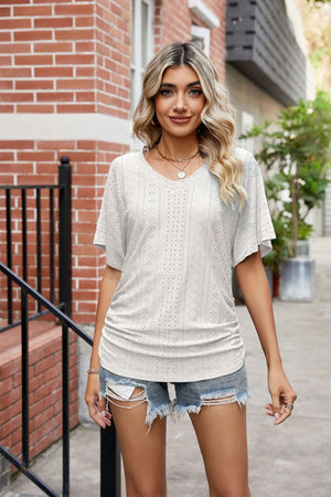 White perforated dolman sleeve blouse with V-neck and side ruching