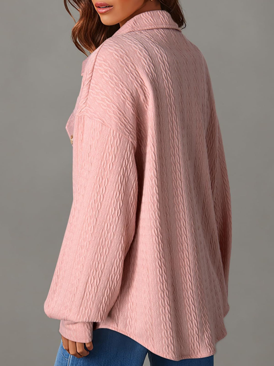 Blush pink textured oversized button-down shacket with a collared neckline and long sleeves.