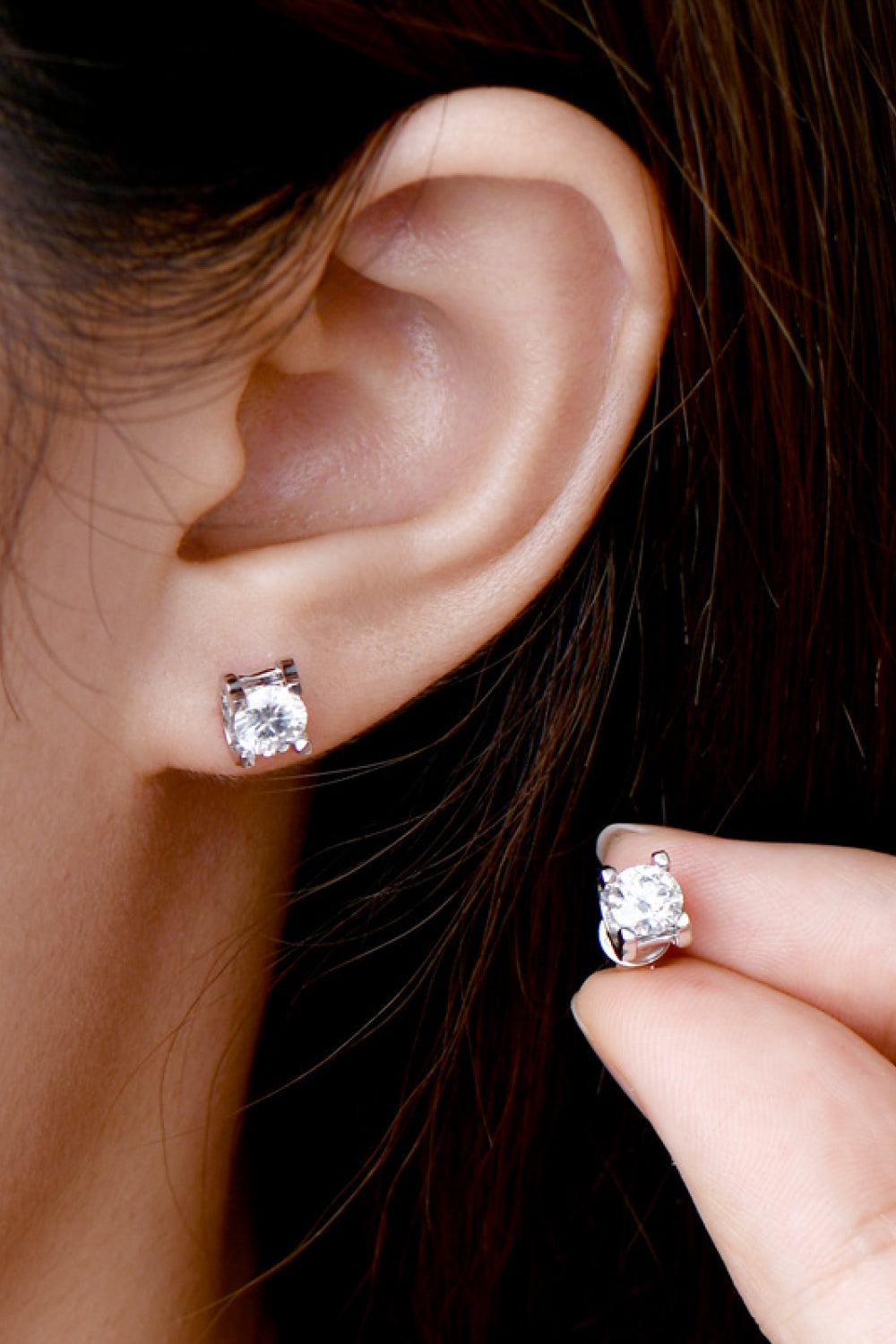 Rose gold moissanite solitaire stud earrings with a four-prong setting.