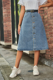 A-line denim midi skirt in medium wash with button detail and a black belt.