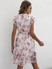 Blush pink floral pleated dress with ruffle sleeves and a belt.