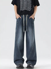 Oversized wide-leg jeans in blue denim with a drawstring waist and vintage-inspired paneling.