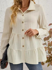 Cream textured tiered button-down shirt with crinkled fabric and button details.