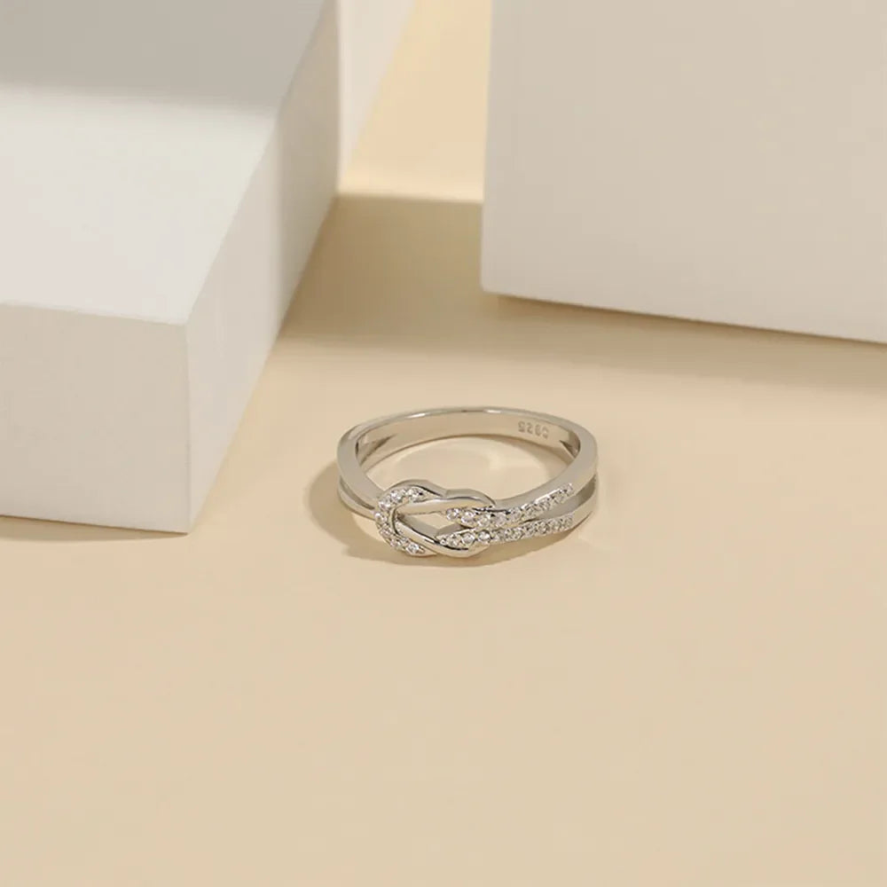 Silver knot ring with pave zirconia detail, 925 sterling silver band.