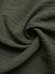 Bohemian maxi dress fabric detail in olive green linen-like material with a textured weave.