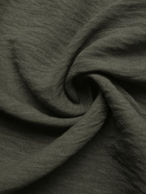 Bohemian maxi dress fabric detail in olive green linen-like material with a textured weave.