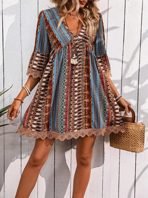 Bohemian printed v-neck dress with bell sleeves and lace trim, featuring a colorful ethnic pattern.