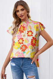Floral smocked neckline blouse with flutter sleeves and a retro floral print.