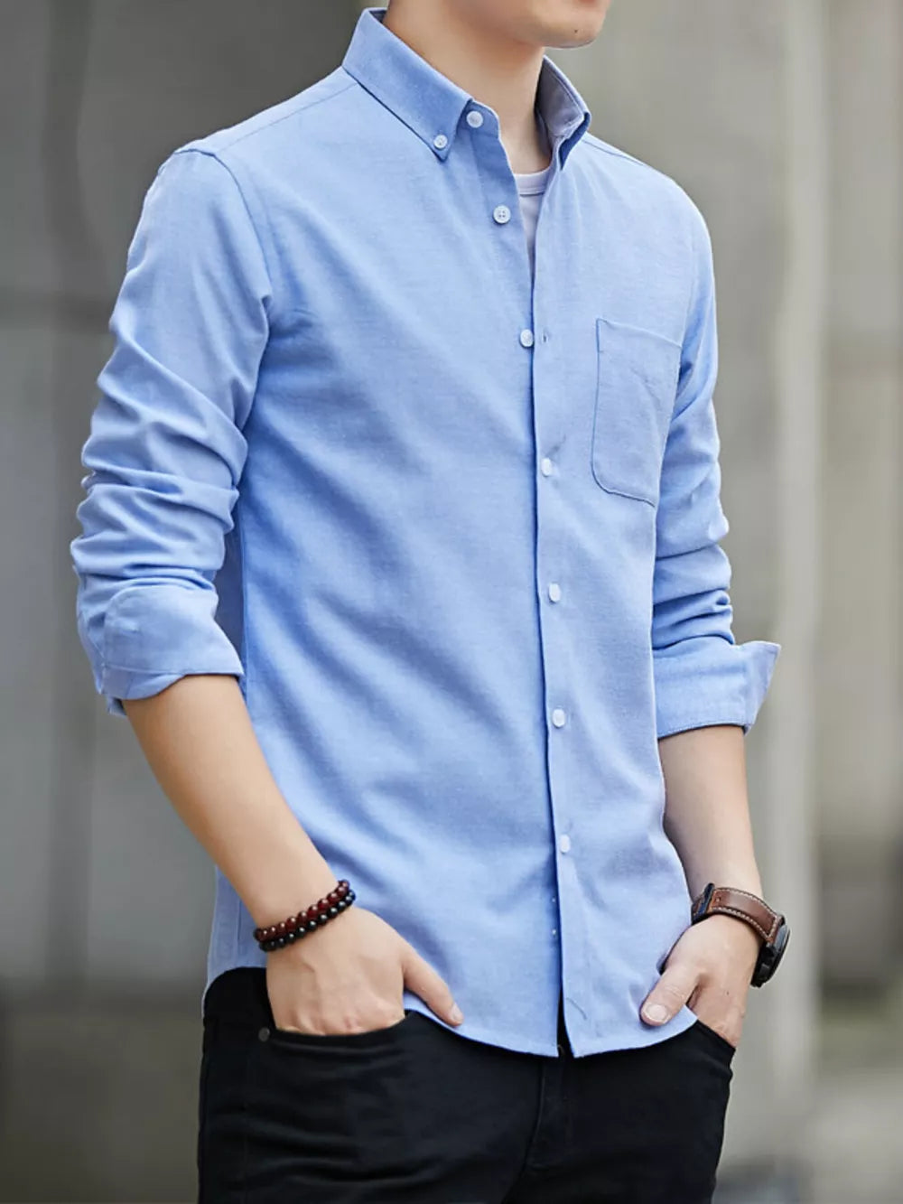 Light blue cotton button-down casual shirt with a chest pocket and buttoned collar.