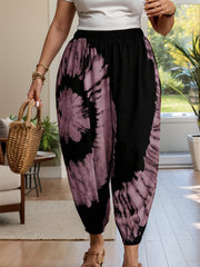 Tie-dye harem trousers in dusty pink and black with elastic waist and relaxed fit.