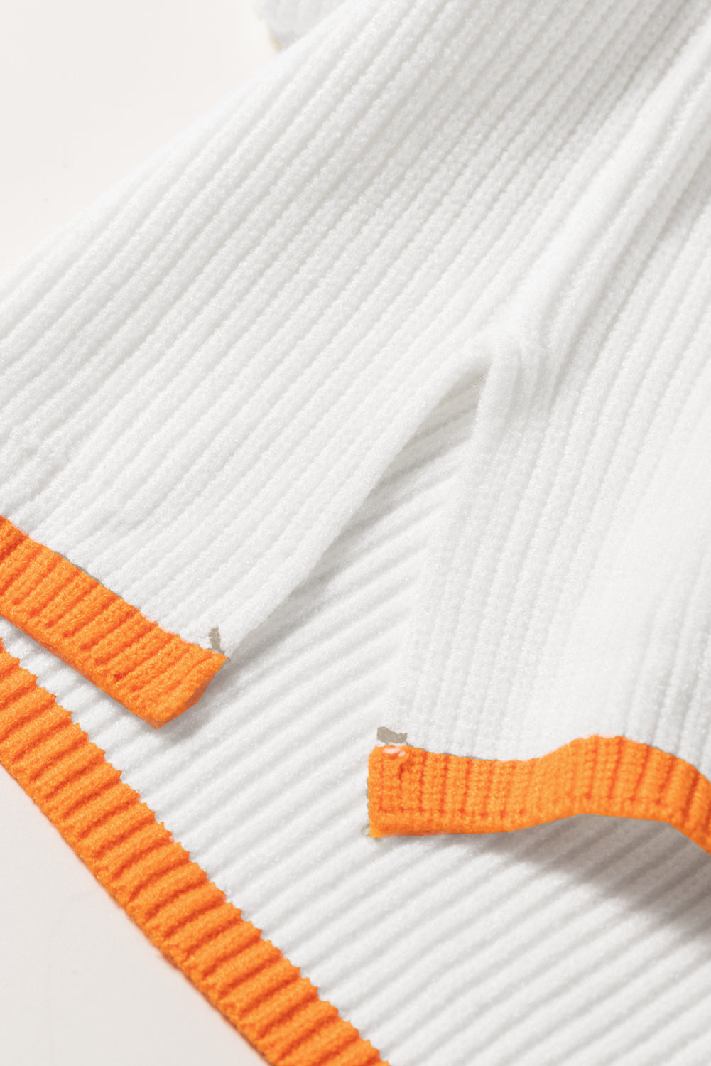 White ribbed quarter-zip pullover with orange trim detail
