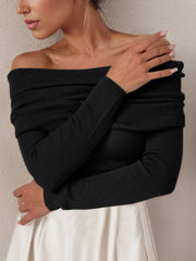 Black ribbed knit off-the-shoulder sweater with long sleeves.
