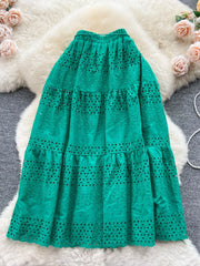 Green eyelet tiered maxi skirt with a ruffled hem and elastic waistband.