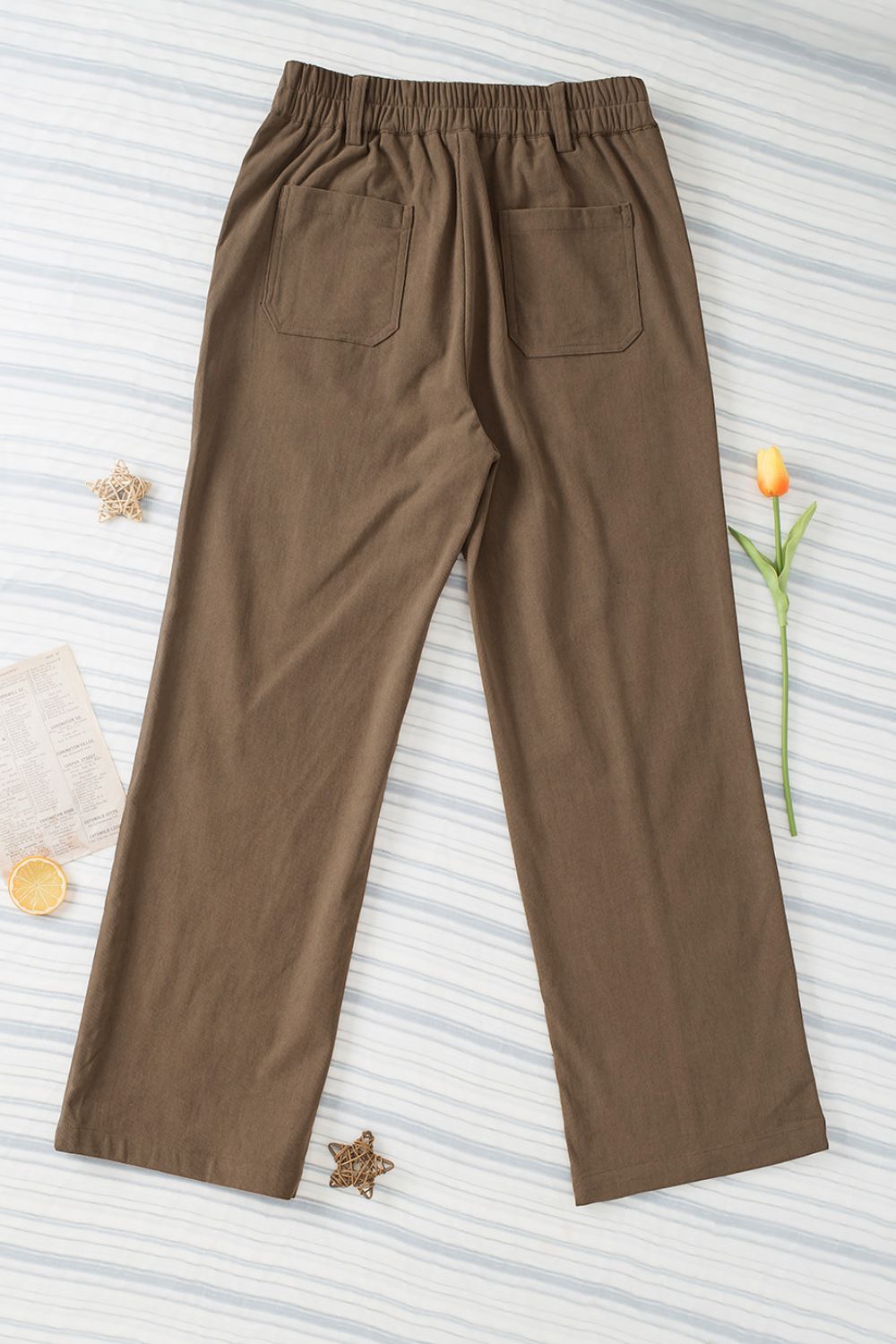 Caramel seamed front wide leg trousers with elastic waist and back pockets.