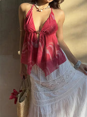Backless halter neck cami in pink abstract print with hook-and-eye closure.