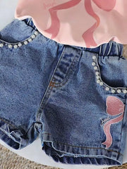 Blush pink tee and blue denim shorts set with pearl trim and bowknot embroidery.