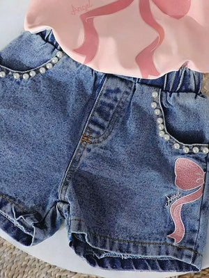 Blush pink tee and blue denim shorts set with pearl trim and bowknot embroidery.