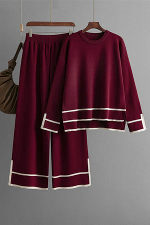 Burgundy acrylic loungewear set with round neck top and sweater pants, featuring white stripe trim.
