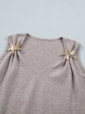 Grey V-neck knit vest with gold star embellishments on shoulders.