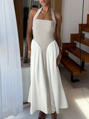 Halter neck two-tone maxi dress with beige bodice and white skirt.